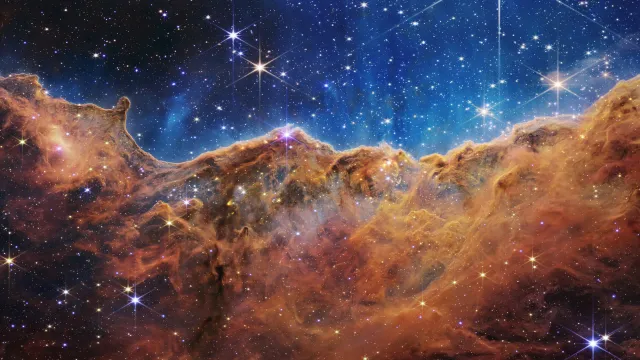 Towering clouds of gas and dust in the Carina Nebula, glittering with young stars